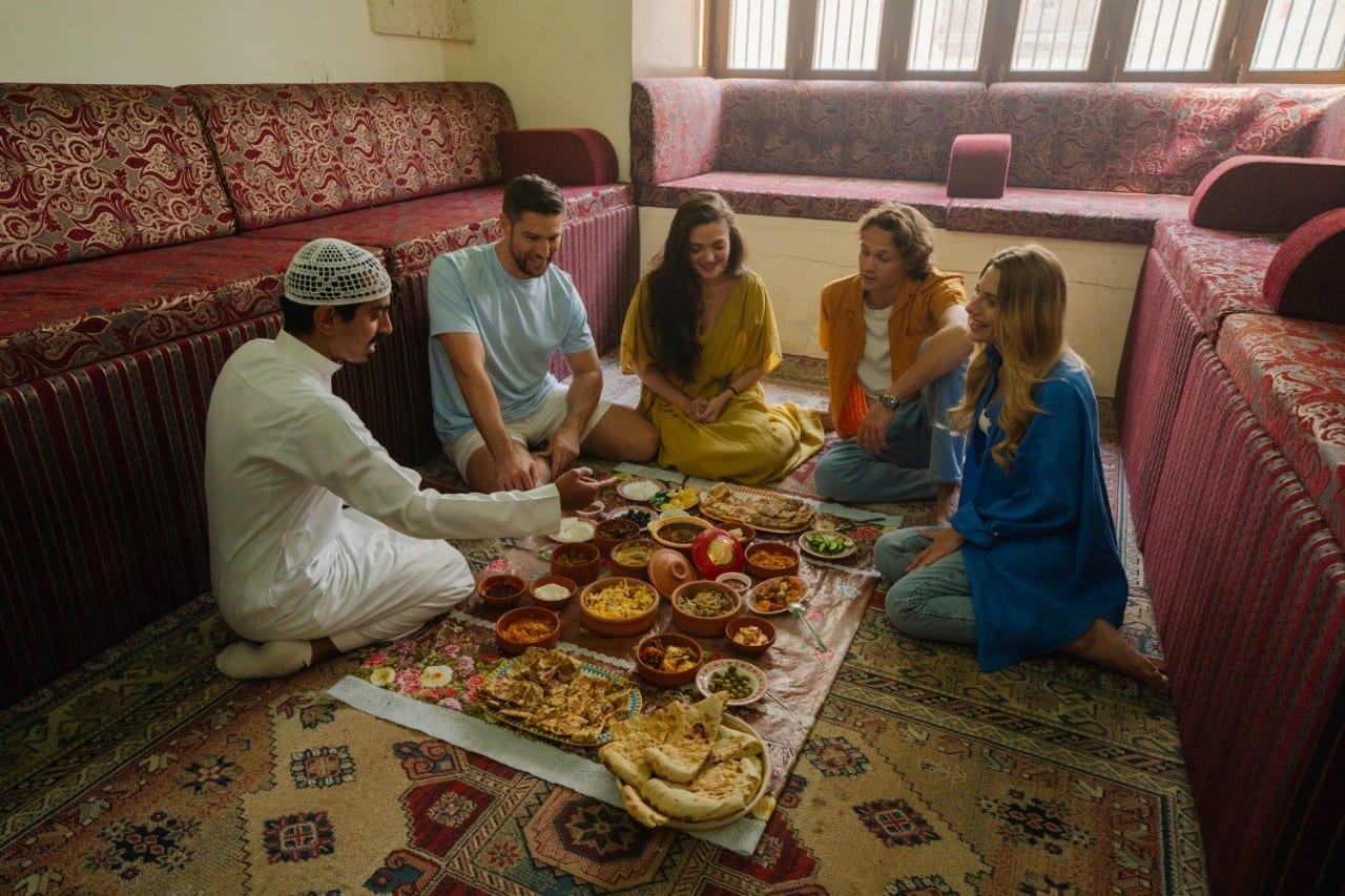 Guests gathering for a traditional meal inside a Bedouin tent