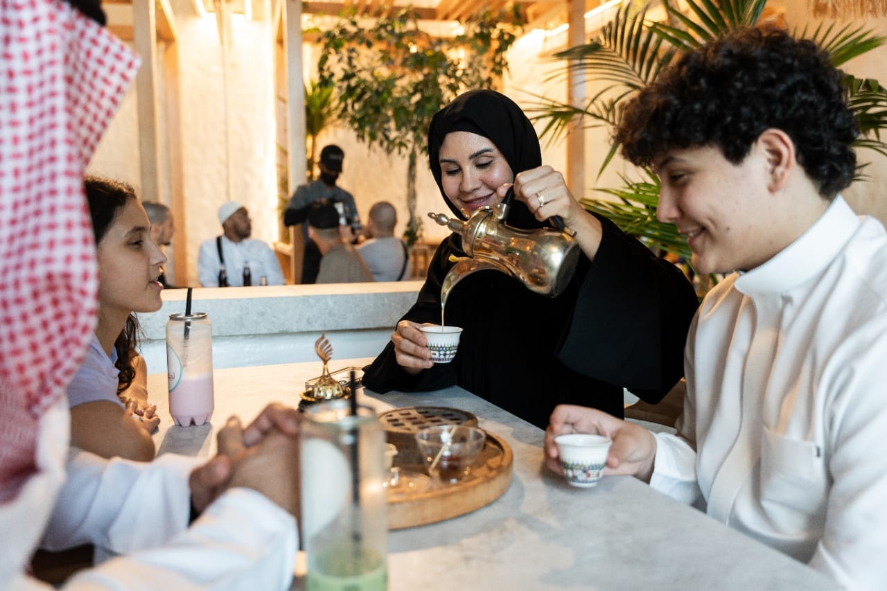 Family sharing Saudi coffee ceremony