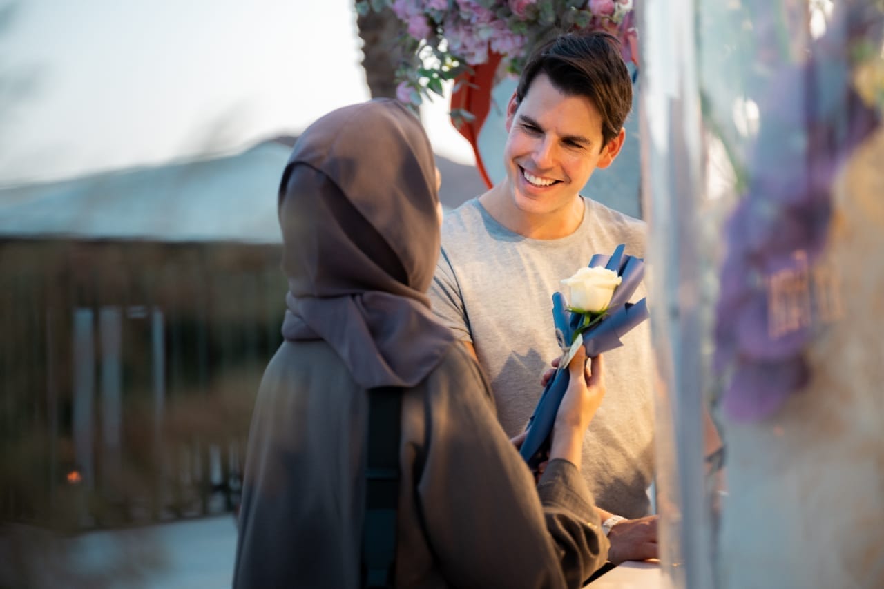 Couple sharing a rose moment in Taif