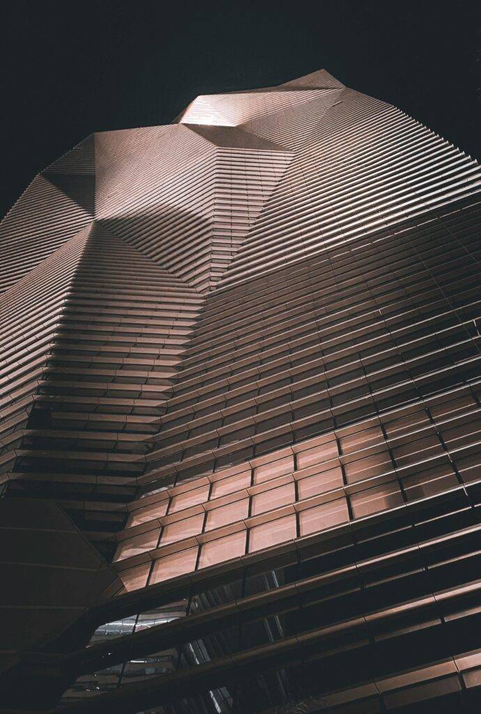Low angle view of a modern skyscraper in Riyadh, showcasing striking architectural details and design.
