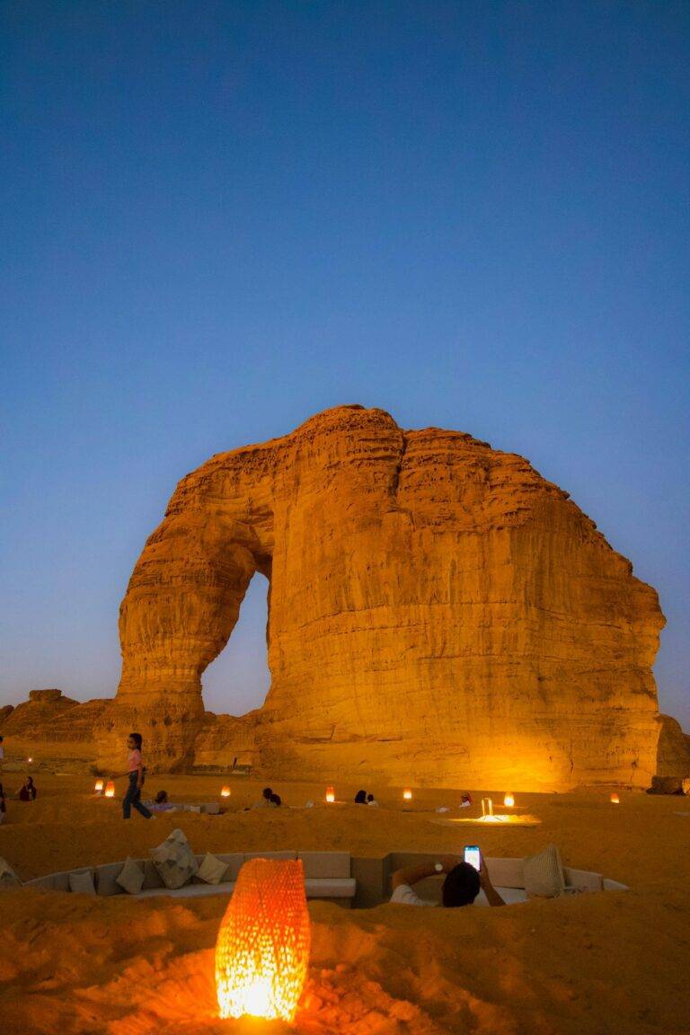 Captivating night scene of the illuminated Elephant Rock in AlUla, featuring stunning desert landscape.