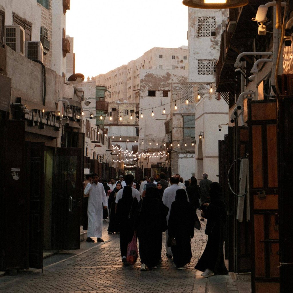 Explore the lively old town Al-Balad in Jeddah, capturing traditional Saudi architecture and culture at sunset.